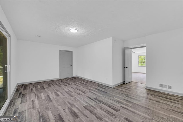 5200 Beechwood Forest Ct, Lithonia, GA 30038 - empty room with wood finished floors and a textured ceiling
