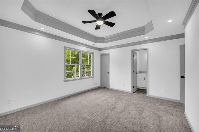 unfurnished bedroom featuring crown molding, carpet flooring, a tray ceiling, recessed lighting, and baseboards