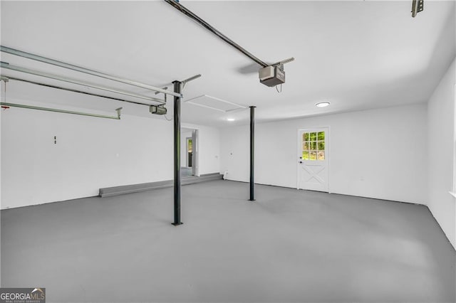 garage with a garage door opener and recessed lighting