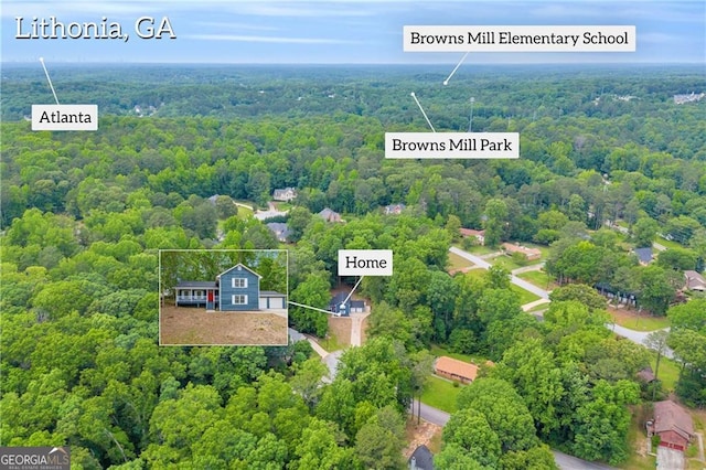 aerial view of property and surrounding area with a forest and property parcel outlined