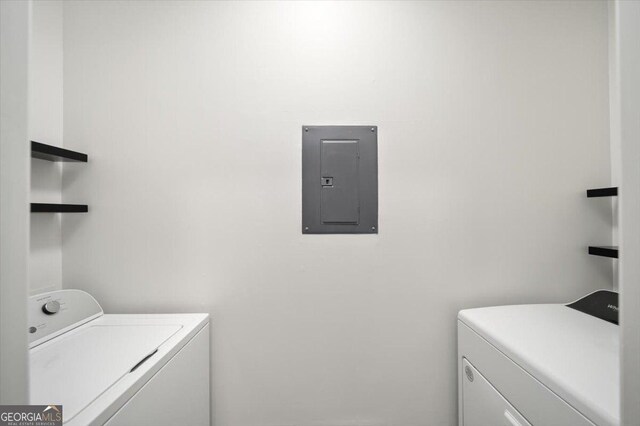 311 Pembrooke Cir, Alpharetta, GA 30004 - clothes washing area with electric panel and washing machine and dryer