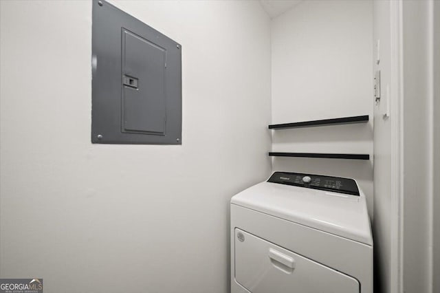 clothes washing area with washer / clothes dryer and electric panel