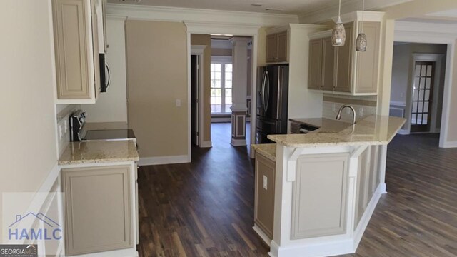 103 Abbie Ln, Glennville, GA 30427 - kitchen featuring appliances with stainless steel finishes, dark wood finished floors, ornamental molding, light stone counters, and a peninsula