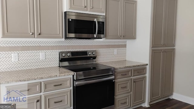 103 Abbie Ln, Glennville, GA 30427 - kitchen featuring appliances with stainless steel finishes, backsplash, baseboards, and light stone counters
