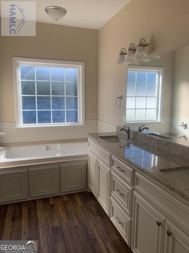 103 Abbie Ln, Glennville, GA 30427 - full bathroom featuring wood finished floors, a garden tub, and double vanity