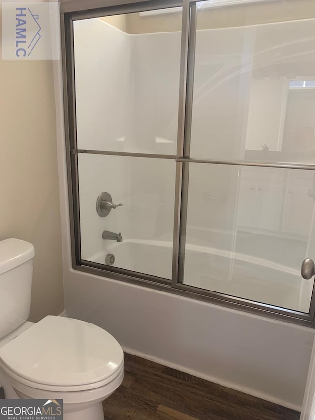 103 Abbie Ln, Glennville, GA 30427 - bathroom with wood finished floors, toilet, and enclosed tub / shower combo