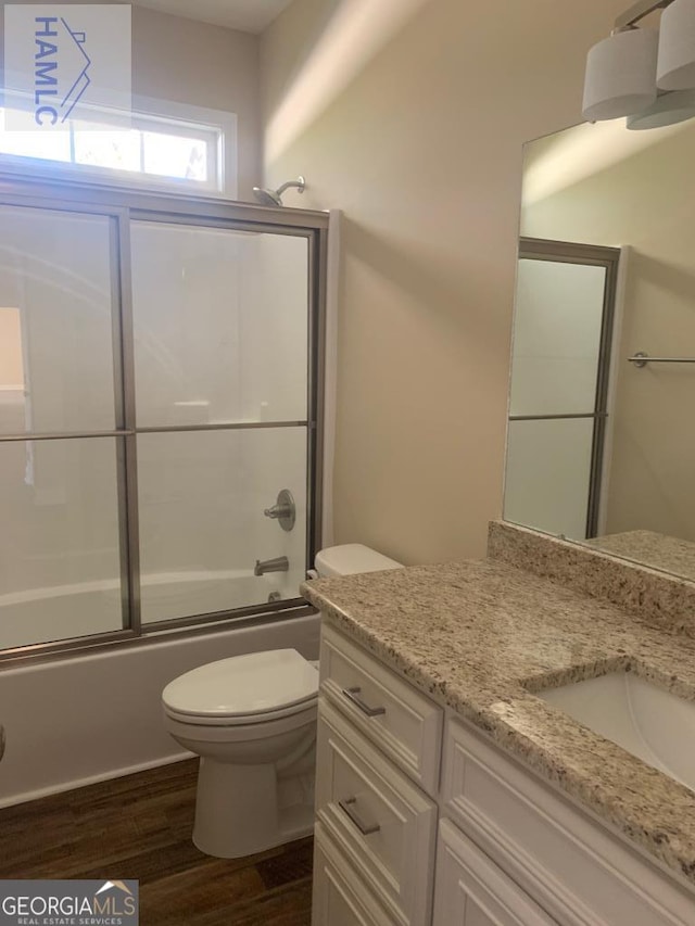 103 Abbie Ln, Glennville, GA 30427 - full bath with wood finished floors, toilet, vanity, and shower / bath combination with glass door