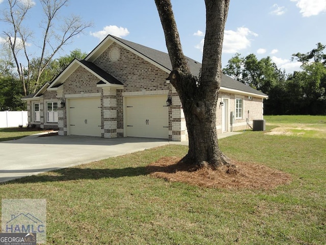 103 Abbie Ln, Glennville, GA 30427 - view of front of property with brick siding, concrete driveway, a garage, and cooling unit