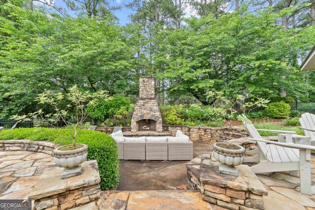 143 Wildwood Dr, Eatonton, GA 31024 - view of patio with fence and an outdoor living space with a fireplace