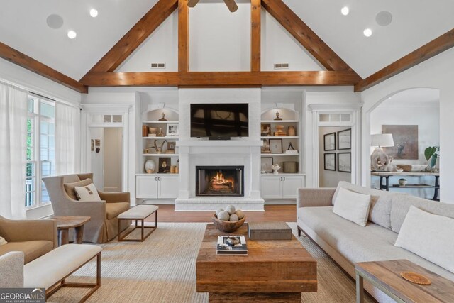 143 Wildwood Dr, Eatonton, GA 31024 - living room with high vaulted ceiling, arched walkways, beam ceiling, a fireplace, and recessed lighting