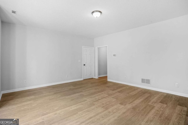 empty room featuring light wood-style floors and baseboards