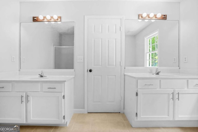 full bathroom featuring a shower stall, tile patterned flooring, and two vanities