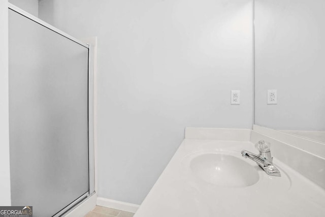 full bath with a stall shower and vanity