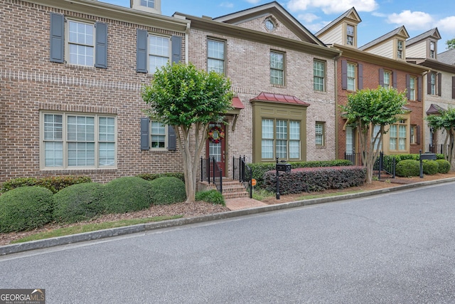 townhome / multi-family property with brick siding
