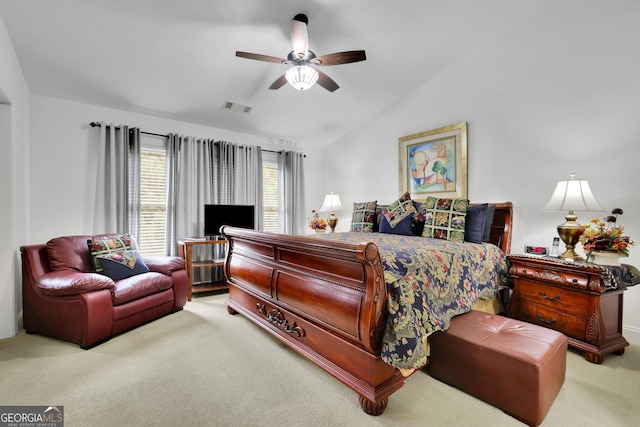 bedroom featuring carpet floors, vaulted ceiling, and a ceiling fan