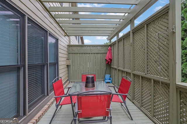 deck featuring outdoor dining area and a pergola