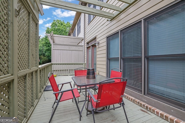 wooden terrace featuring outdoor dining area