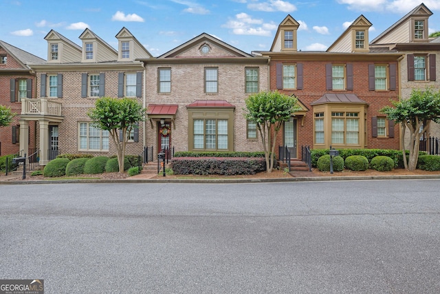 townhome / multi-family property featuring brick siding