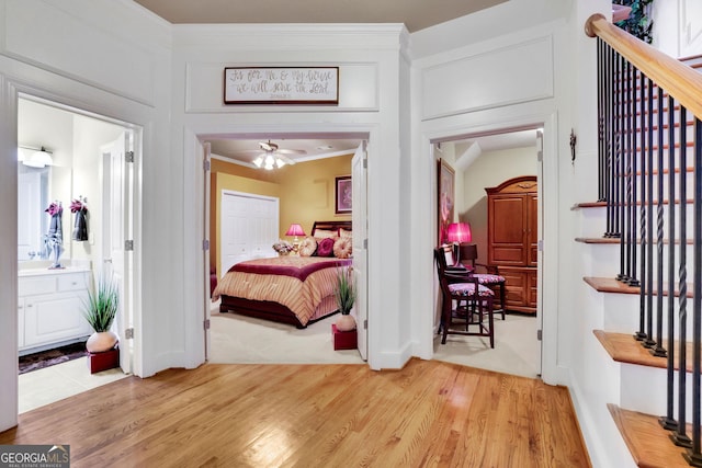 bedroom with light wood-type flooring and ensuite bathroom