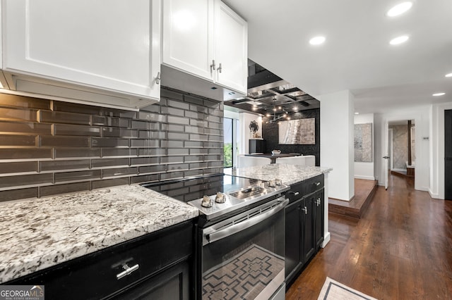 130 26th St NW Unit 801, Atlanta, GA 30309 - kitchen featuring electric range, white cabinets, decorative backsplash, recessed lighting, and light stone counters