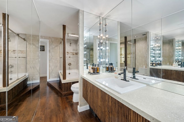 130 26th St NW Unit 801, Atlanta, GA 30309 - full bathroom featuring toilet, wood finished floors, tiled shower, and a tub to relax in