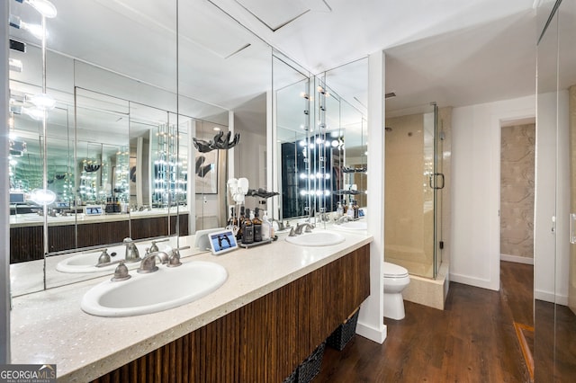 130 26th St NW Unit 801, Atlanta, GA 30309 - bathroom with a stall shower, wood finished floors, double vanity, and toilet