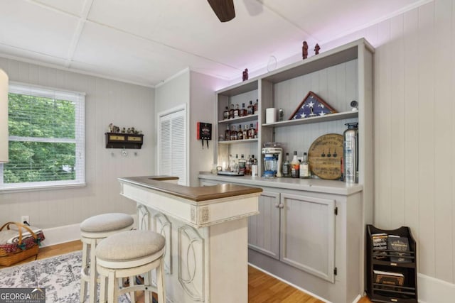 1280 Sherry Dr, Alpharetta, GA 30009 - indoor dry bar with light wood-style floors, a ceiling fan, wooden walls, and baseboards