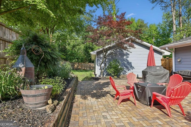 view of patio with a fenced backyard and area for grilling