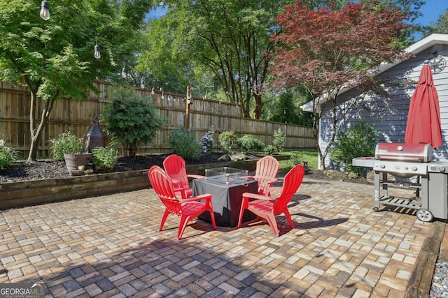 1280 Sherry Dr, Alpharetta, GA 30009 - fenced backyard with an outdoor fire pit, grilling area, and a patio