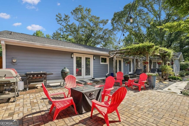 view of patio with french doors, a fire pit, and grilling area