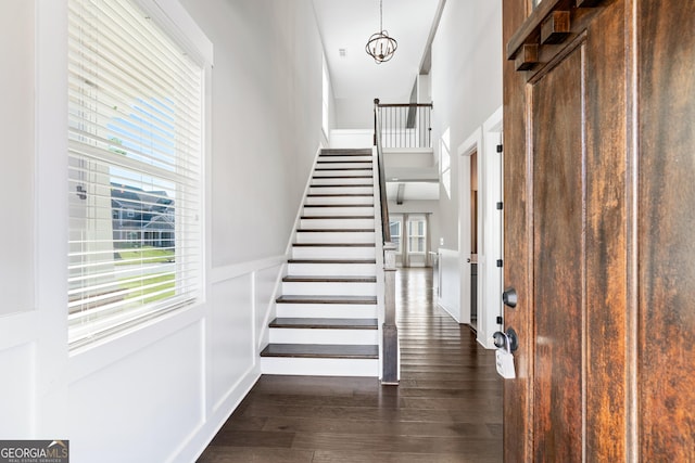 133 Wild Turkey Pass, Homer, GA 30547 - entryway with stairway, dark wood-type flooring, a high ceiling, wainscoting, and a decorative wall