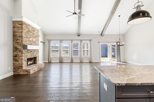 133 Wild Turkey Pass, Homer, GA 30547 - unfurnished living room featuring a ceiling fan, dark wood-style floors, a brick fireplace, a chandelier, and baseboards