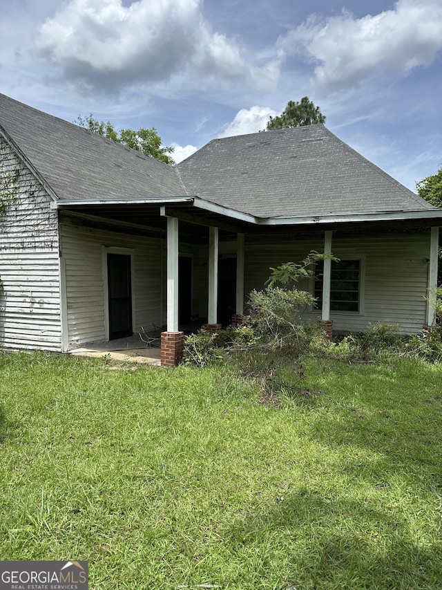 35 Hancock St, Warm Springs, GA 31830 - rear view of property featuring a lawn and roof with shingles