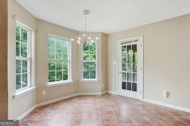 259 Pine Valley Dr, Powder Springs, GA 30127 - unfurnished dining area with tile patterned flooring and a chandelier
