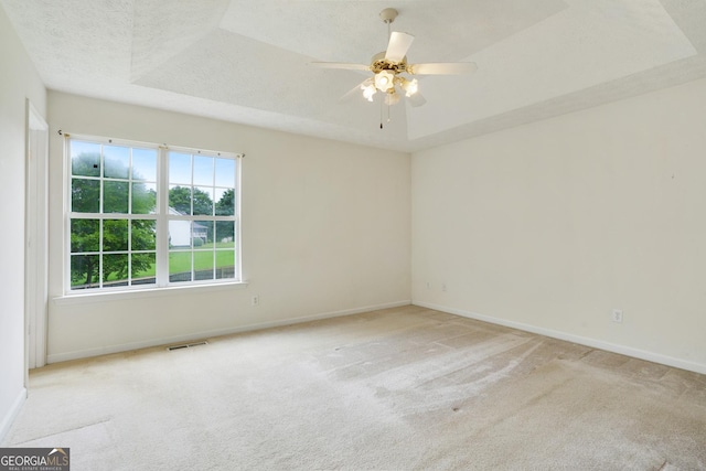 259 Pine Valley Dr, Powder Springs, GA 30127 - spare room with carpet, ceiling fan, and a raised ceiling