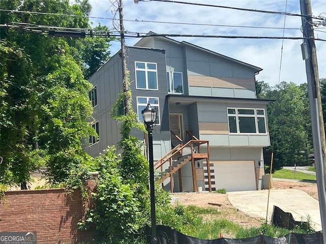 4107 Danforth, Atlanta, GA 30331 - contemporary house featuring concrete driveway, a garage, and stairway