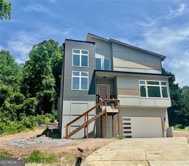 4107 Danforth, Atlanta, GA 30331 - contemporary home with a garage, stairway, concrete driveway, and stucco siding