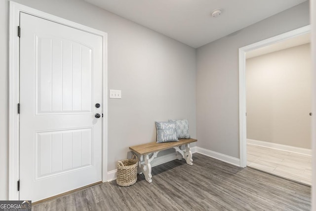 mudroom featuring wood finished floors and baseboards