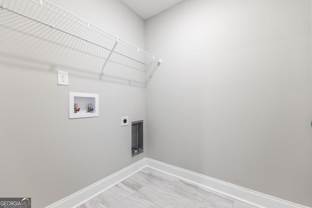 laundry area featuring baseboards, hookup for an electric dryer, light marble finish floors, and hookup for a washing machine