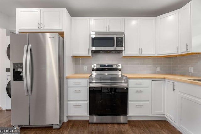 kitchen with appliances with stainless steel finishes, wooden counters, white cabinetry, and dark wood-style flooring