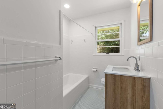 full bathroom featuring tile walls, tile patterned floors, toilet, vanity, and shower / bath combination