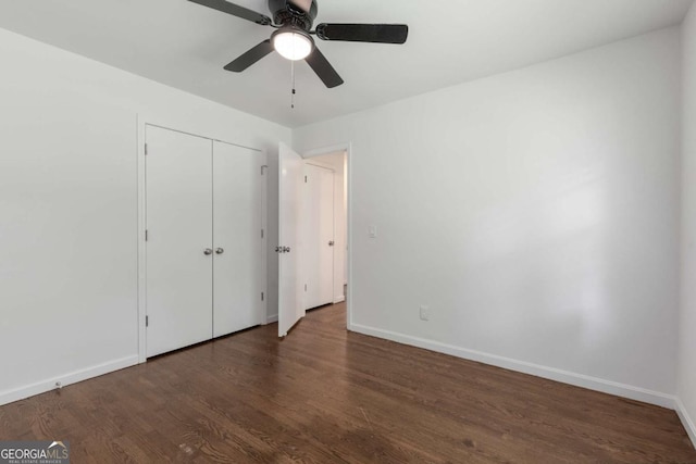 unfurnished bedroom with wood finished floors, baseboards, a closet, and a ceiling fan