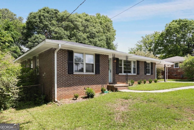 view of front of home with brick siding and a front lawn
