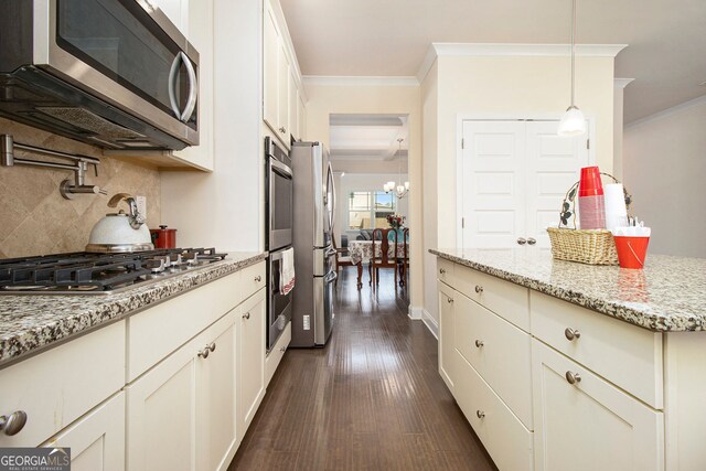 320 Conley Ave, Hampton, GA 30228 - kitchen with appliances with stainless steel finishes, crown molding, decorative backsplash, dark wood-style flooring, and light stone counters