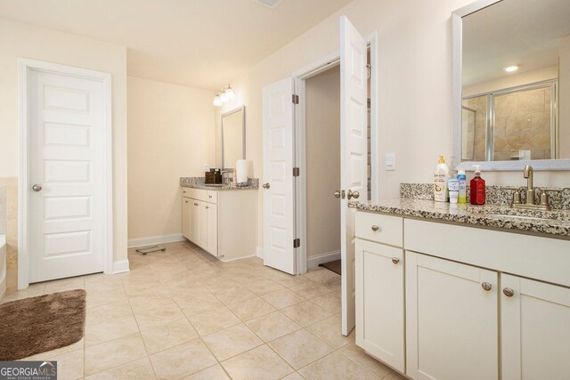 320 Conley Ave, Hampton, GA 30228 - full bathroom with two vanities, a shower stall, and tile patterned floors