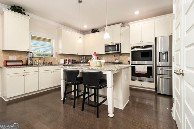 320 Conley Ave, Hampton, GA 30228 - kitchen featuring stainless steel appliances, recessed lighting, a kitchen island, light stone counters, and tasteful backsplash