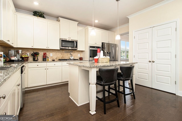 320 Conley Ave, Hampton, GA 30228 - kitchen with stainless steel appliances, decorative backsplash, ornamental molding, dark wood-type flooring, and white cabinets
