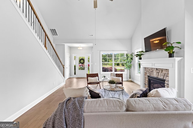 10 Georgian Oaks Ct, Newnan, GA 30265 - living room with a towering ceiling, stairs, a fireplace, baseboards, and wood finished floors