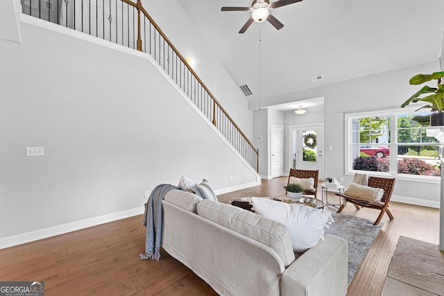 10 Georgian Oaks Ct, Newnan, GA 30265 - living room with high vaulted ceiling, stairs, a ceiling fan, hardwood / wood-style floors, and baseboards