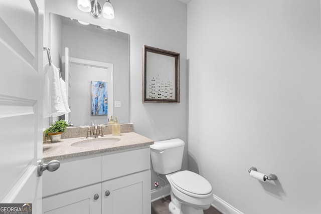 10 Georgian Oaks Ct, Newnan, GA 30265 - half bathroom featuring toilet, vanity, and baseboards